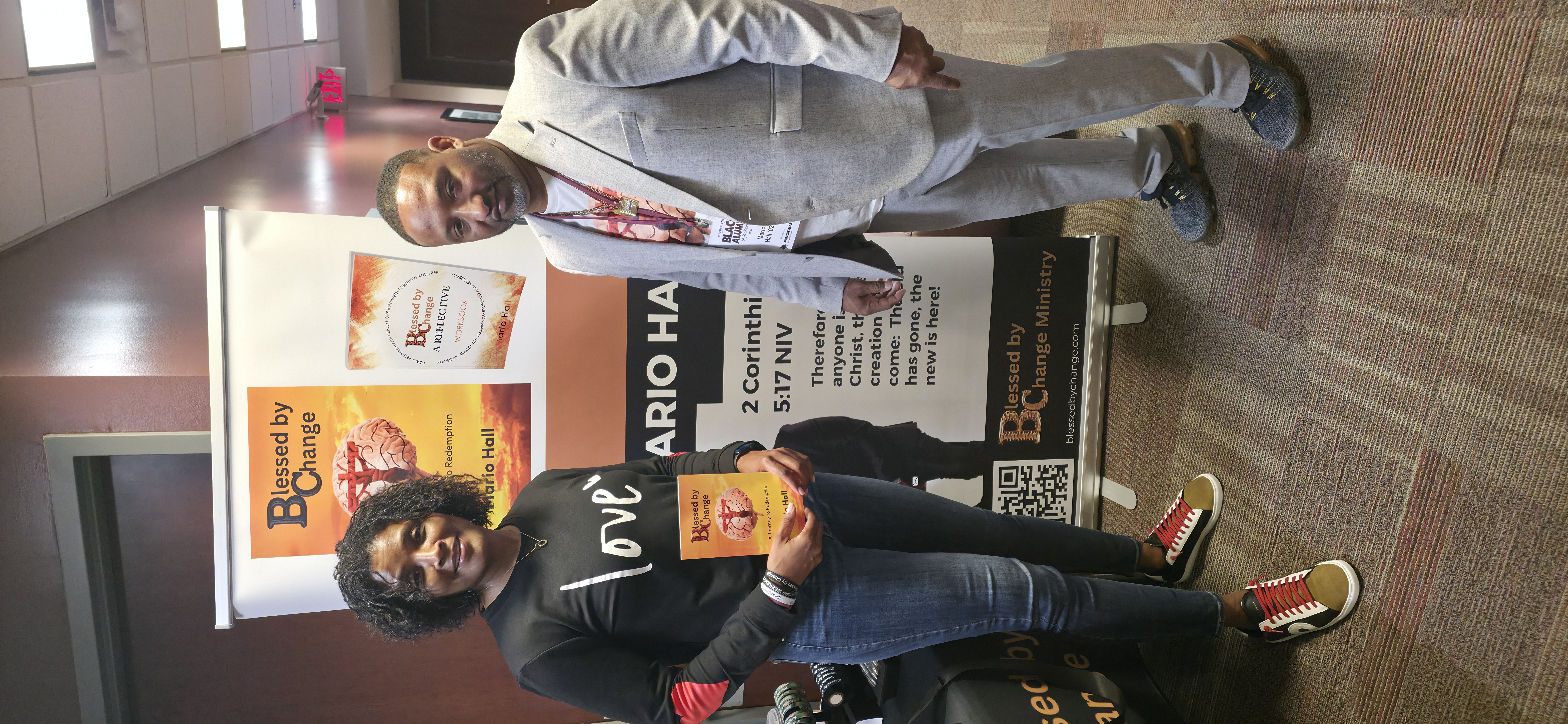 Mario Hall with event attendee holding Blessed By Change book