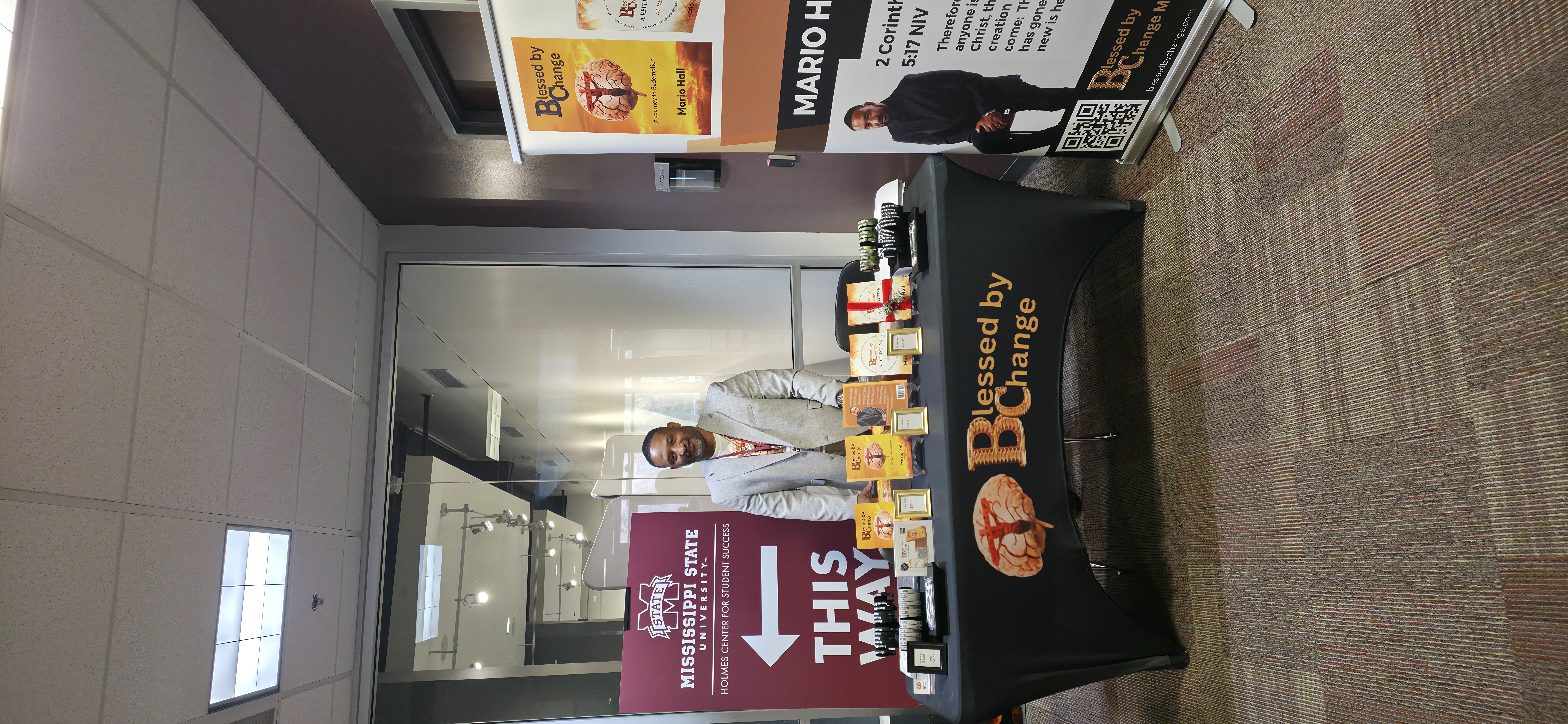 Mario Hall at book signing table at Mississippi State University