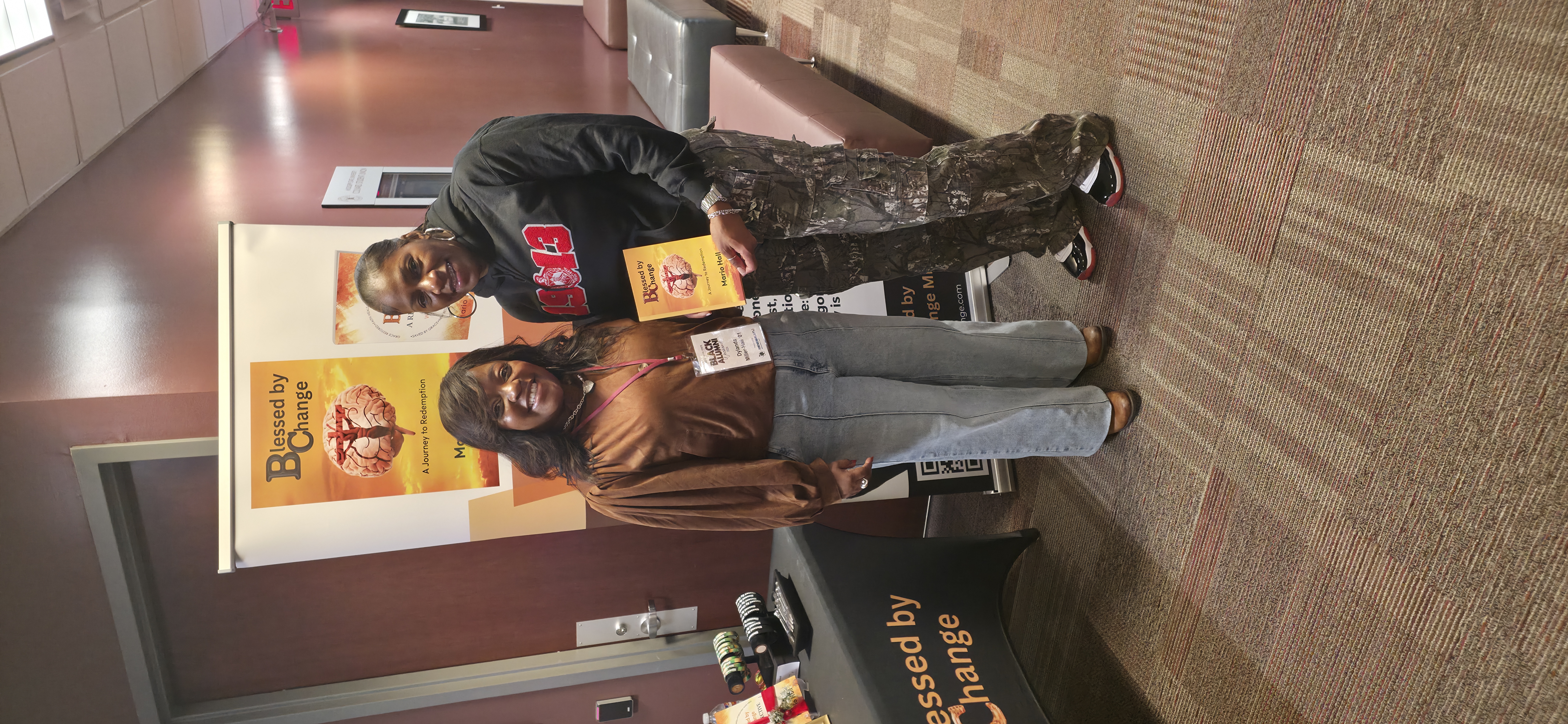 Mario Hall with community member at book signing